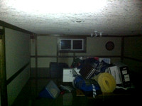 Basement, shot from the stair across the pool table.  Water coming in around the window which could pop at any moment.
