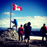 A group rigging a new flag on the summit